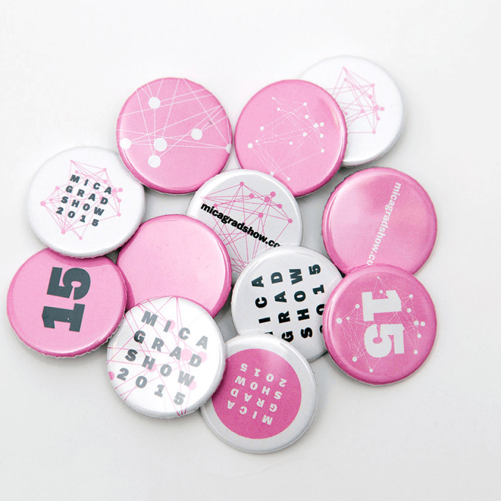 Photo of 1 inch buttons of various designs for the MICA Grad Show
